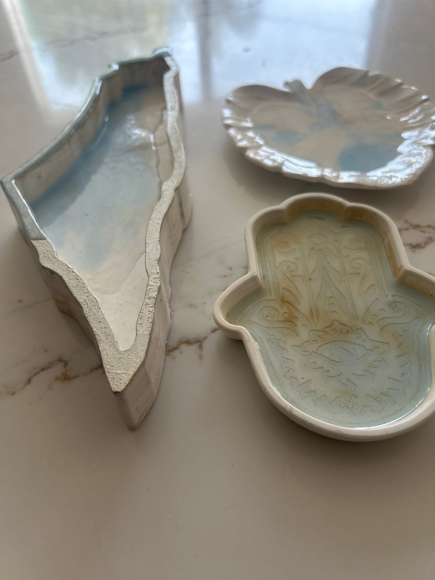 Tray designs inspired by the Map of Israel, Hamsa & Leaf